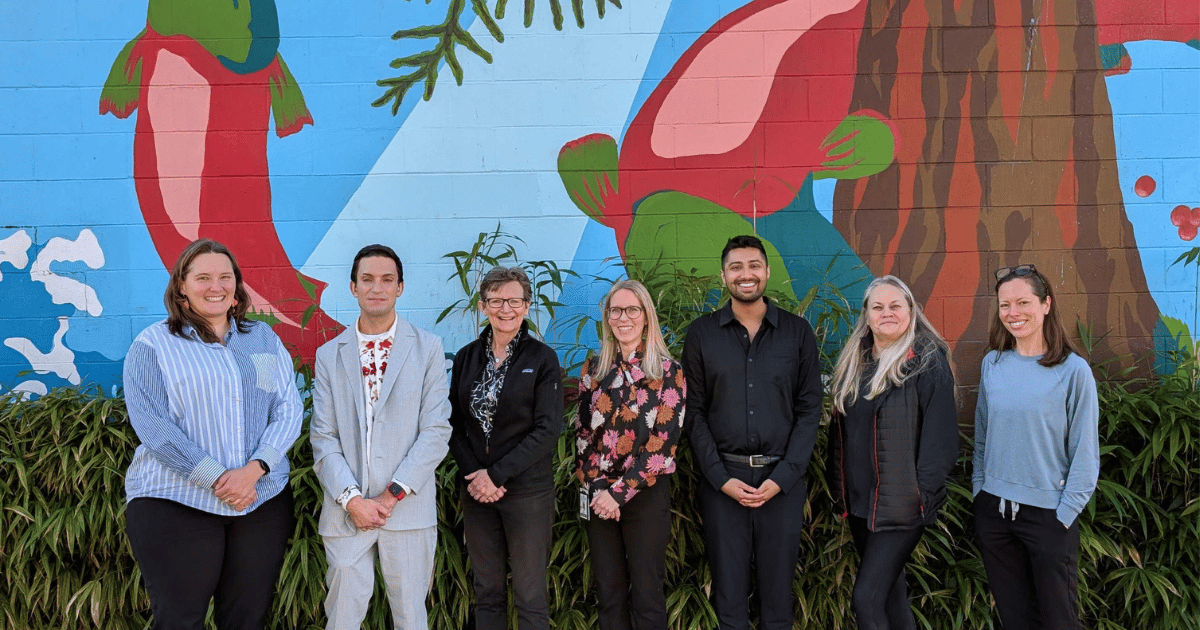 Kilala Lelum team with BCCDC and PPHF staff outside Kilala Lelum building with mural